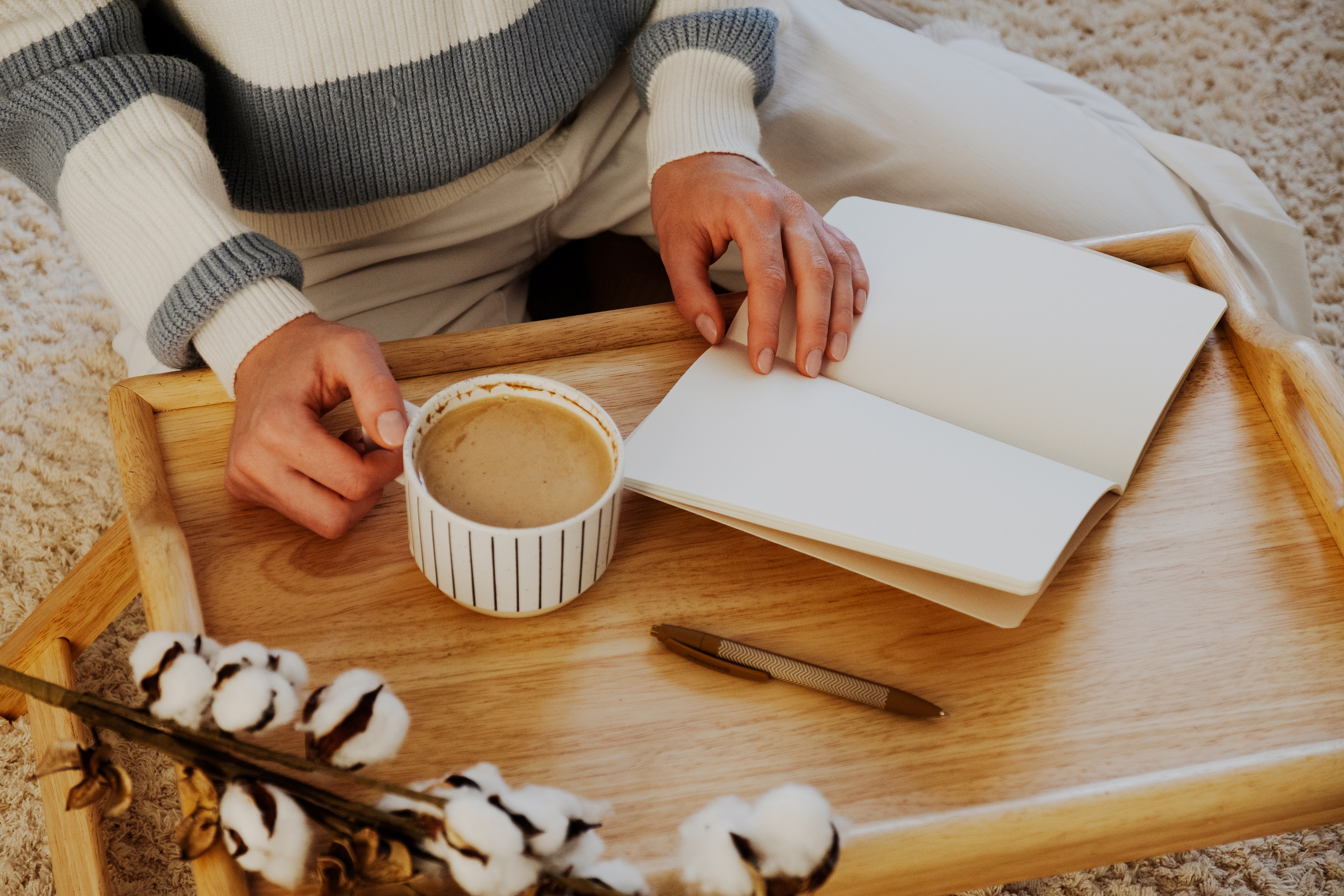 Woman with blank notebook and cup of coffee